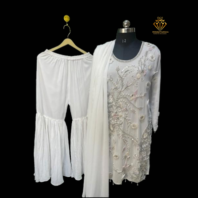 This stunning white sharara set features intricate embroidery that exudes timeless elegance