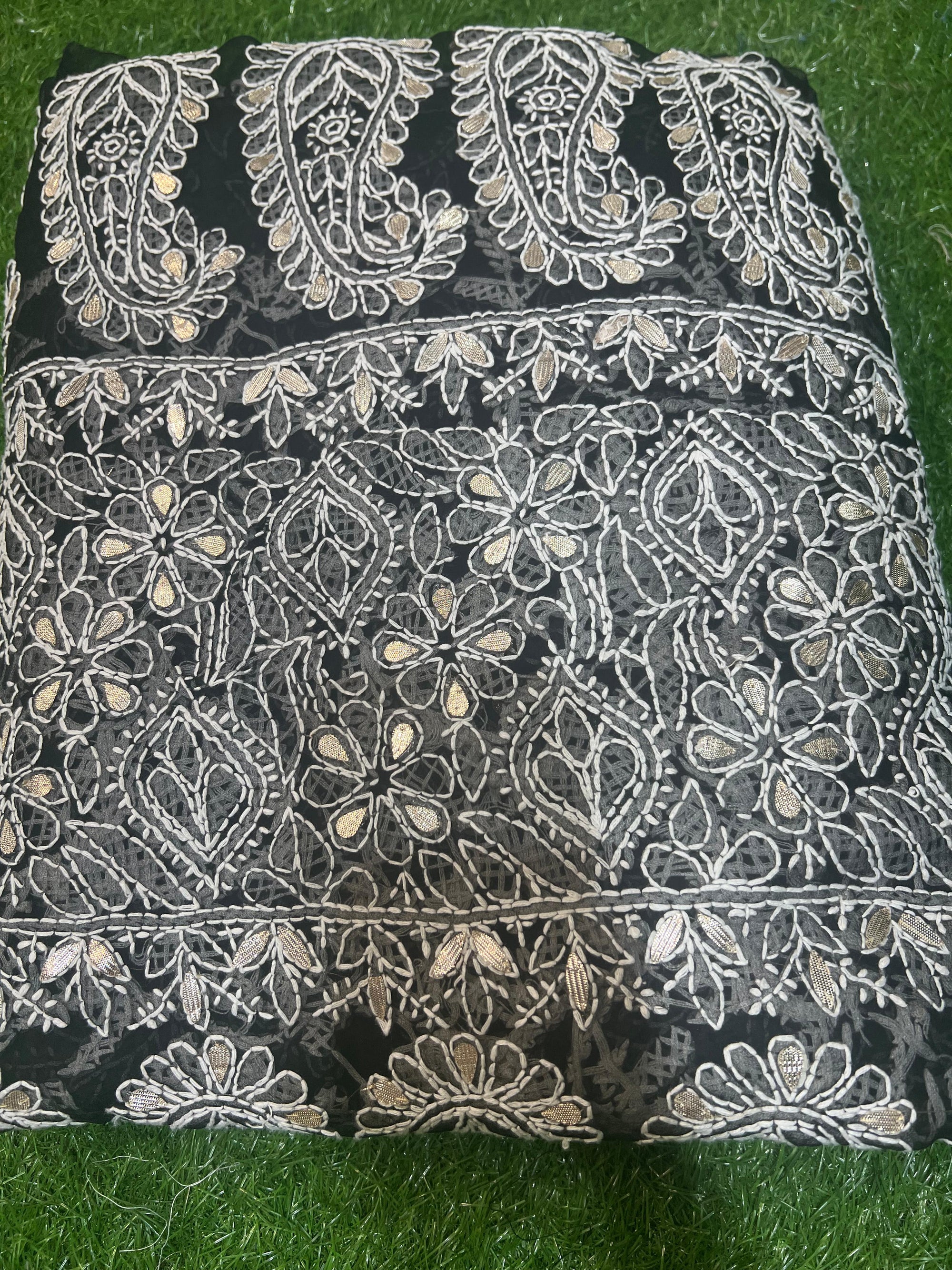 This exquisite black georgette saree features intricate hand-embroidered Lucknowi Chikankari, showcasing the timeless artistry of traditional craftsmanship